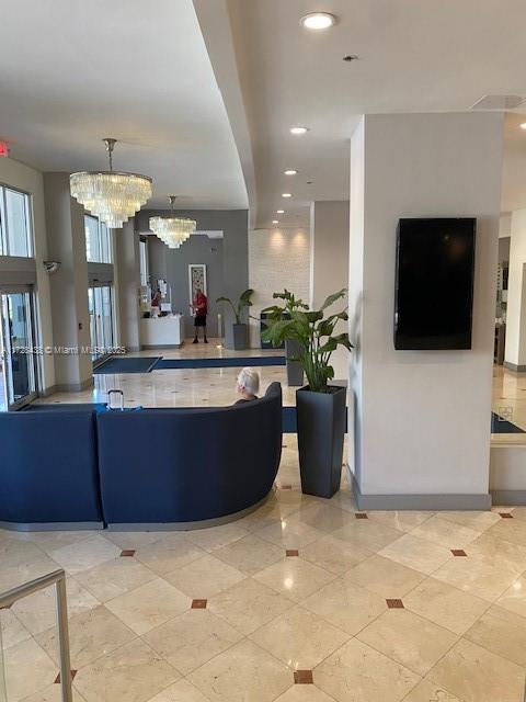 100 Lincoln Road, Unit 616 Miami Beach, FL 33139 - Photo 22 of 31 a view of a living room kitchen and a flat screen tv
