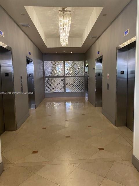 100 Lincoln Road, Unit 616 Miami Beach, FL 33139 - Photo 24 of 31 a view of a hallway with a chandelier