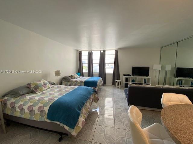 100 Lincoln Road, Unit 616 Miami Beach, FL 33139 - Photo 3 of 31 a bedroom with bed or furniture and a flat screen tv