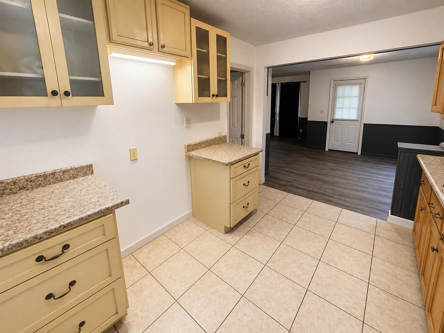 8488 Quito Road Millington, TN 38053 - Photo 3 of 30 a kitchen with granite countertop white cabinets and white appliances