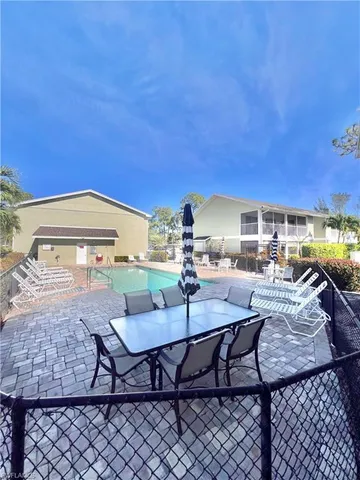 a view of a chairs and table in patio