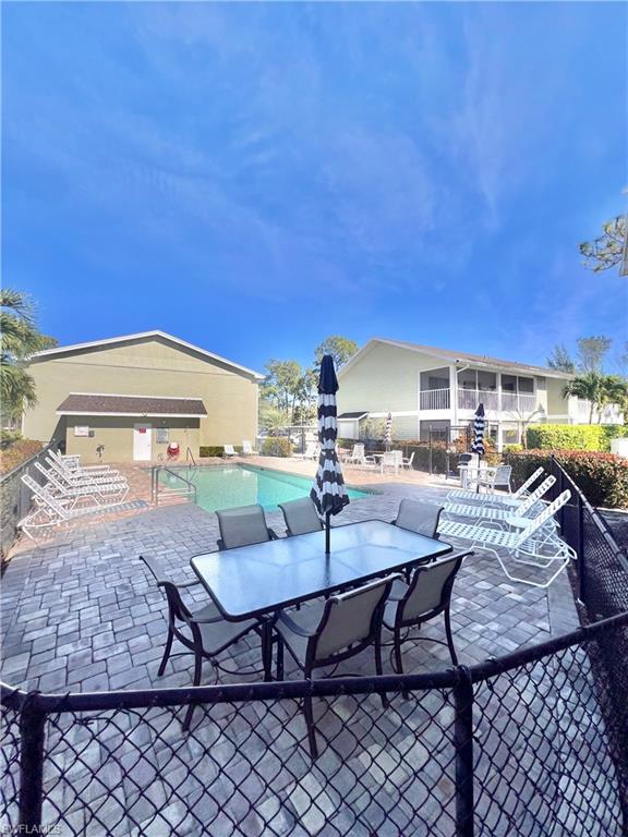 295 Quail Forest Boulevard, Unit 119 Naples, FL 34105 - Photo 23 of 26 a view of a chairs and table in patio
