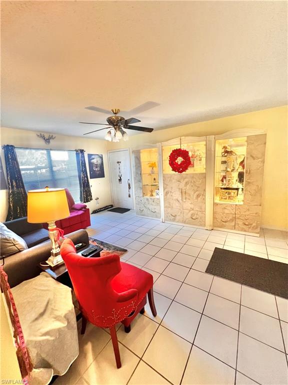 295 Quail Forest Boulevard, Unit 119 Naples, FL 34105 - Photo 4 of 26 a bedroom with furniture and a mirror