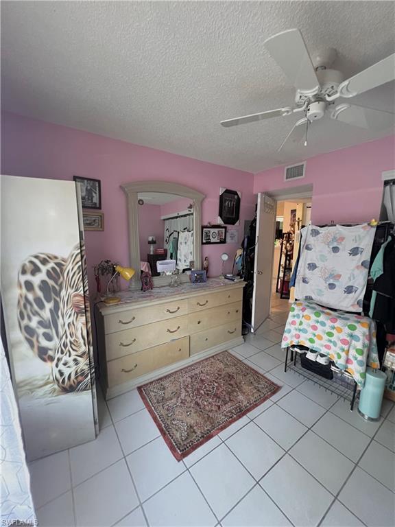 295 Quail Forest Boulevard, Unit 119 Naples, FL 34105 - Photo 7 of 26 a room with toys and dresser