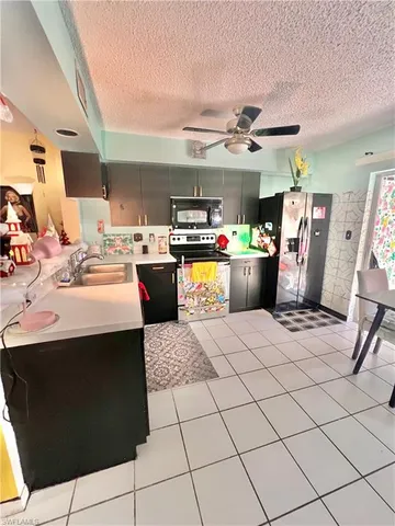 a kitchen with a sink a stove and cabinets