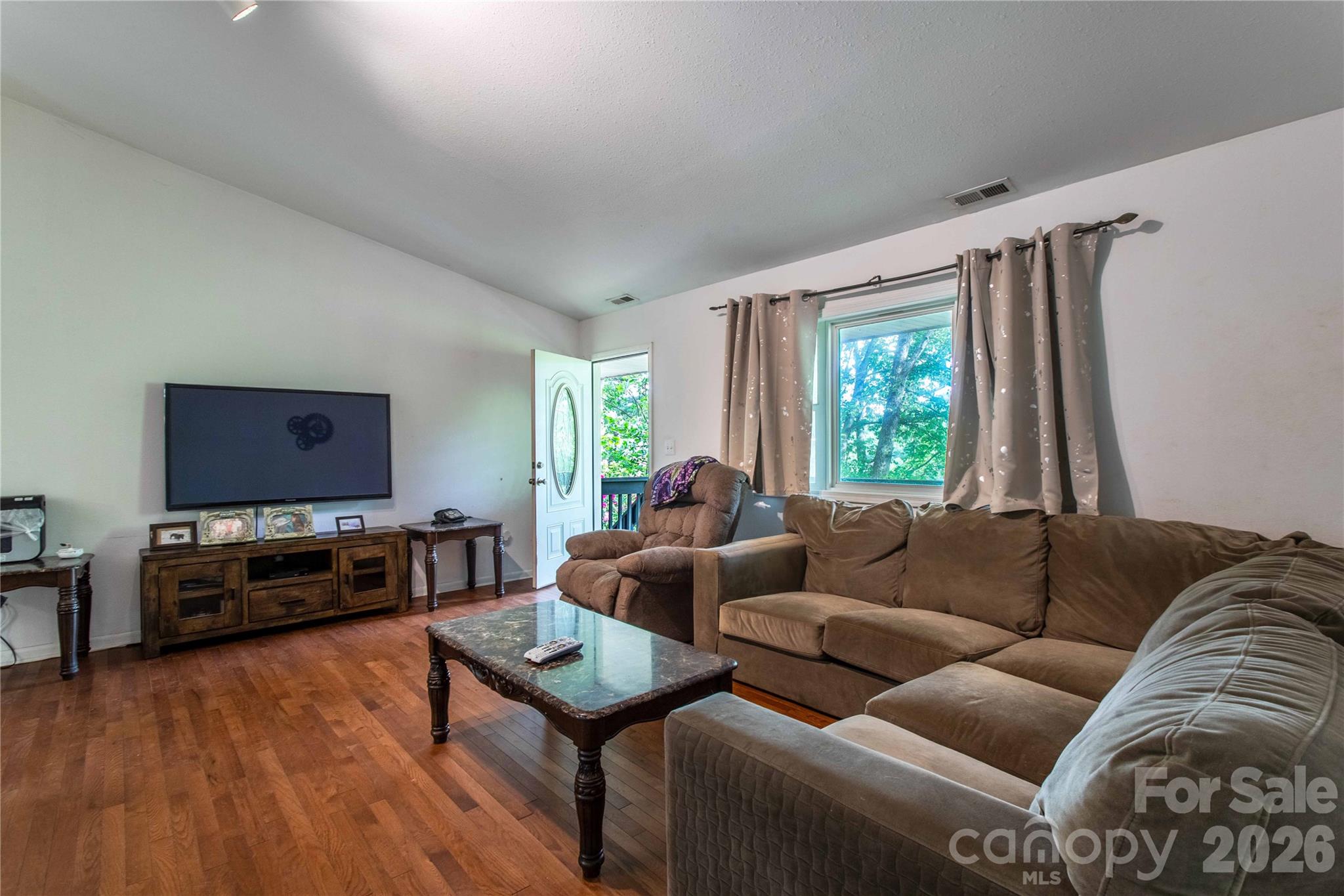 115 Knoll Ridge Waynesville, NC 28785 - Photo 13 of 35 a living room with furniture and a flat screen tv