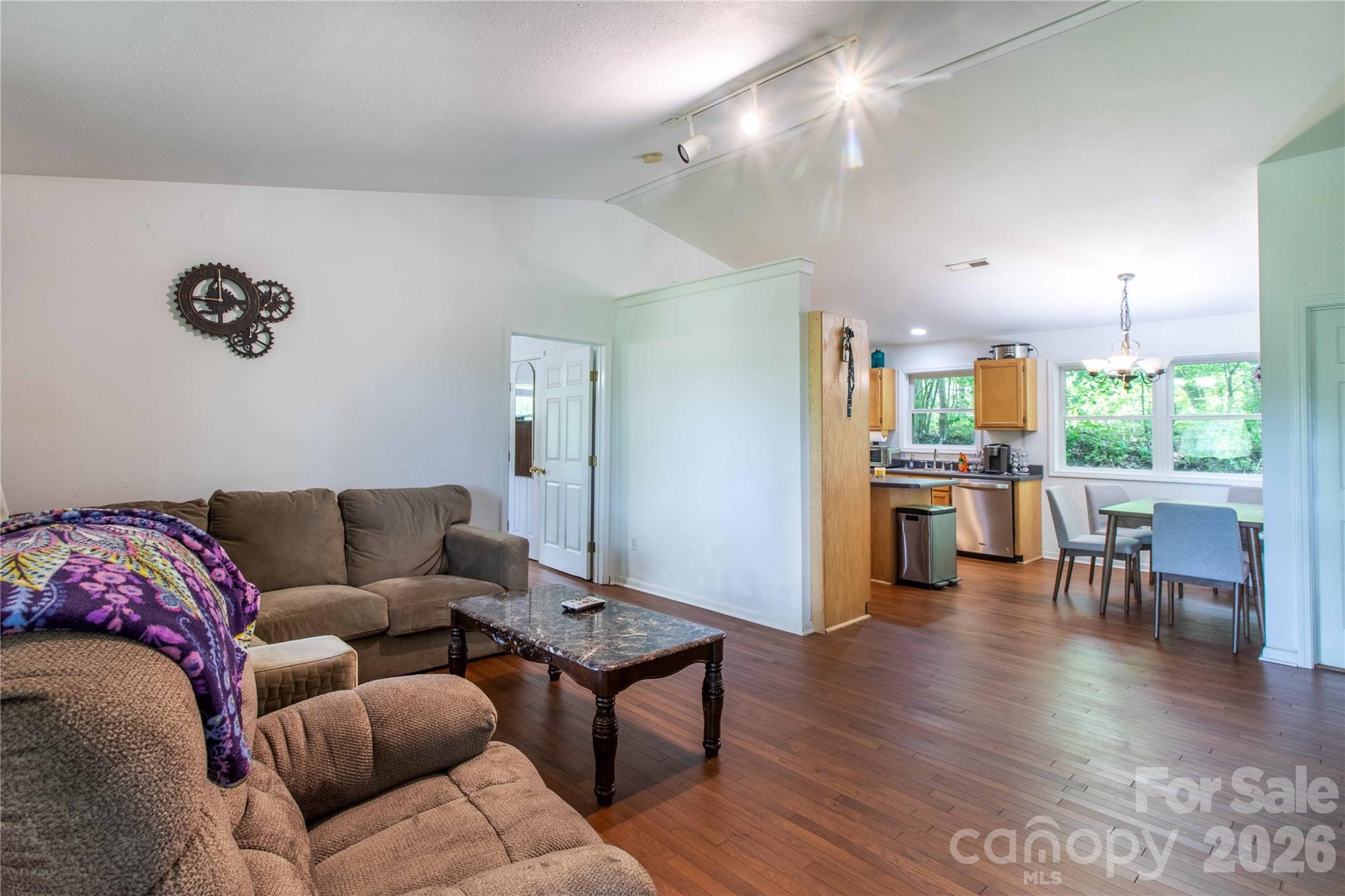 115 Knoll Ridge Waynesville, NC 28785 - Photo 18 of 35 a living room with furniture wooden floor and kitchen view