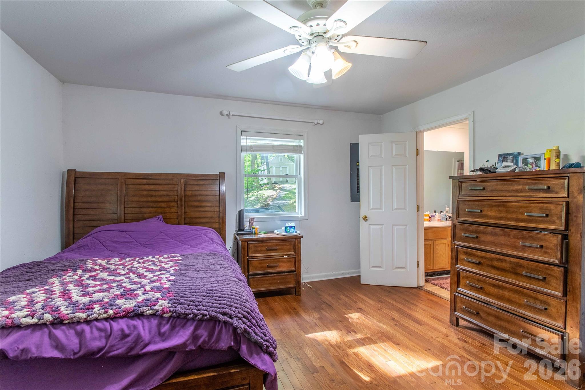115 Knoll Ridge Waynesville, NC 28785 - Photo 22 of 35 a bedroom with a bed and a chandelier