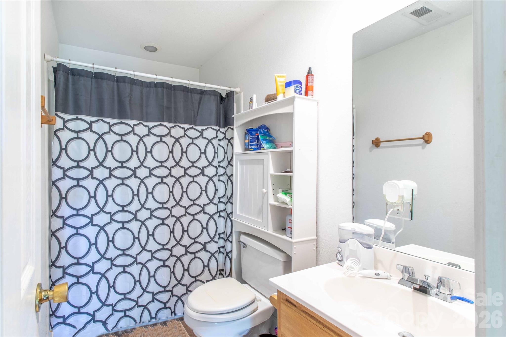 115 Knoll Ridge Waynesville, NC 28785 - Photo 28 of 35 a bathroom with a sink a toilet and shower curtain
