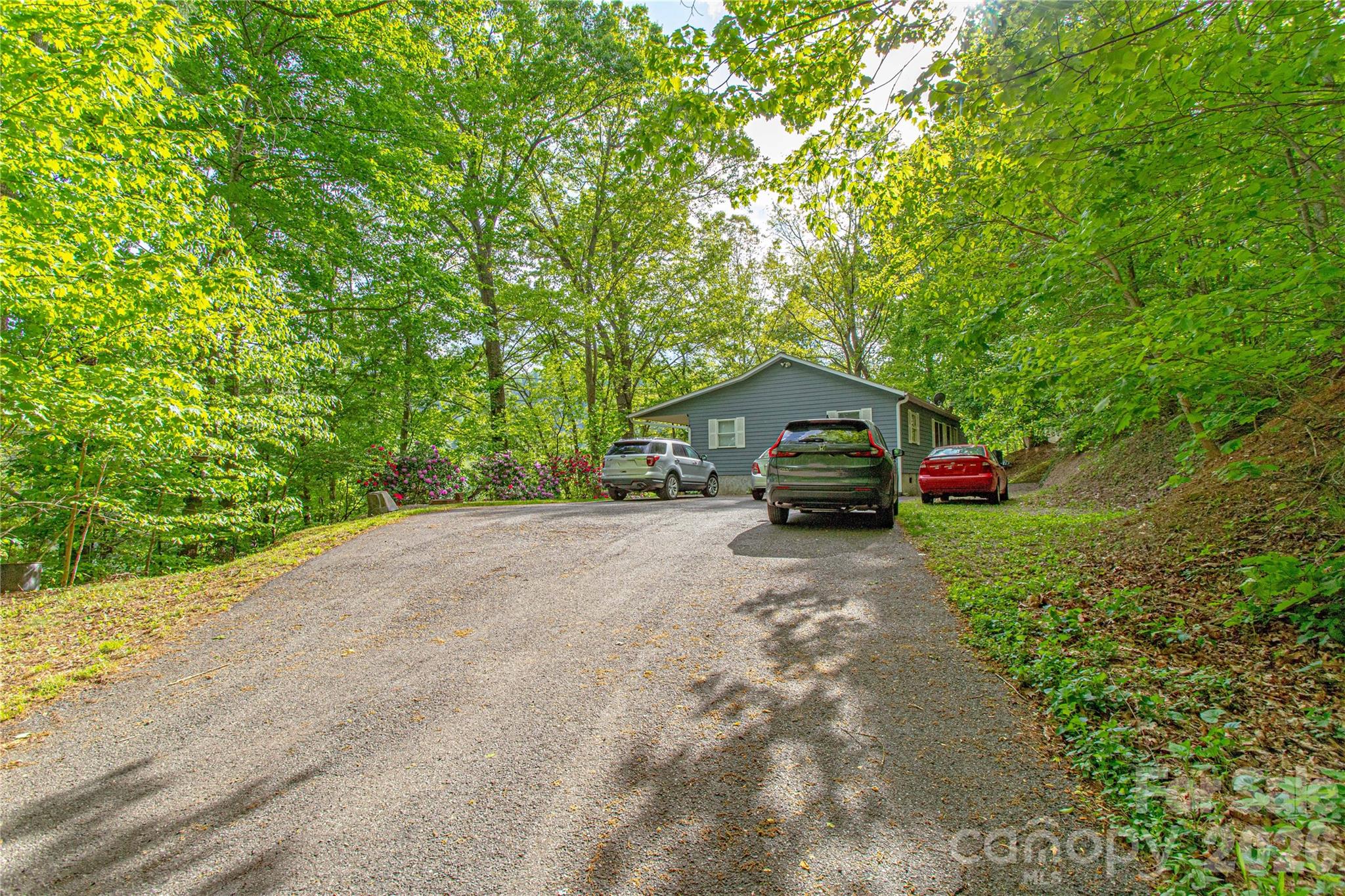 115 Knoll Ridge Waynesville, NC 28785 - Photo 31 of 35 a car parked in front of a house with a small yard