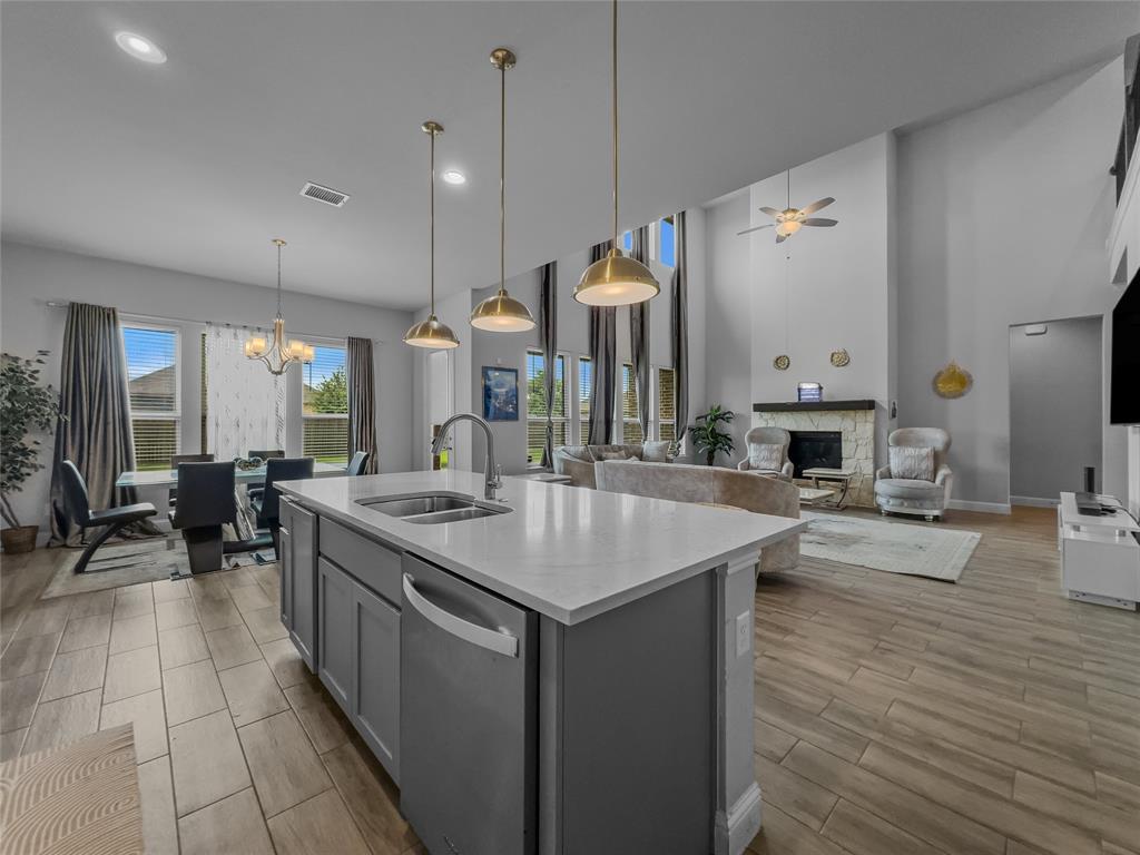 116 Chaco Drive Forney, TX 75126 - Photo 6 of 27 a kitchen with a sink counter top space and living room view