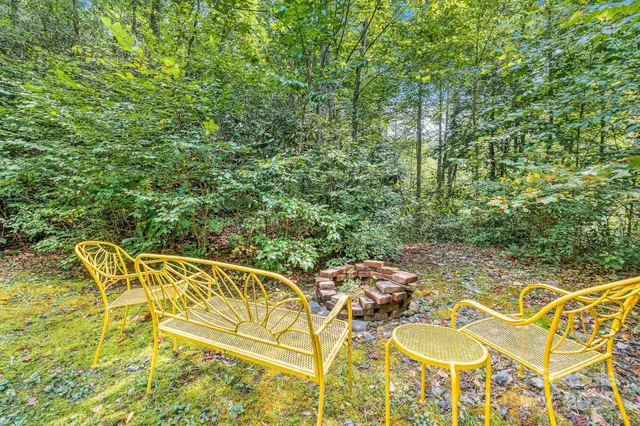 a backyard of a house with table and chairs