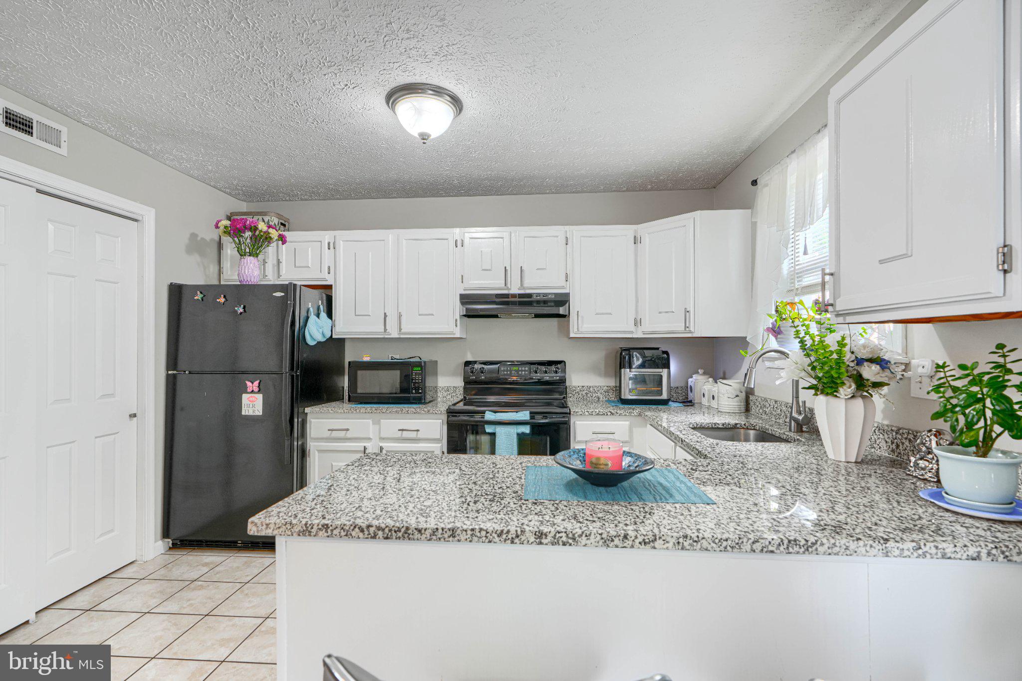 4067 Rustico Road Baltimore, MD 21220 - Photo 13 of 31 Modern kitchen with sleek finishes.