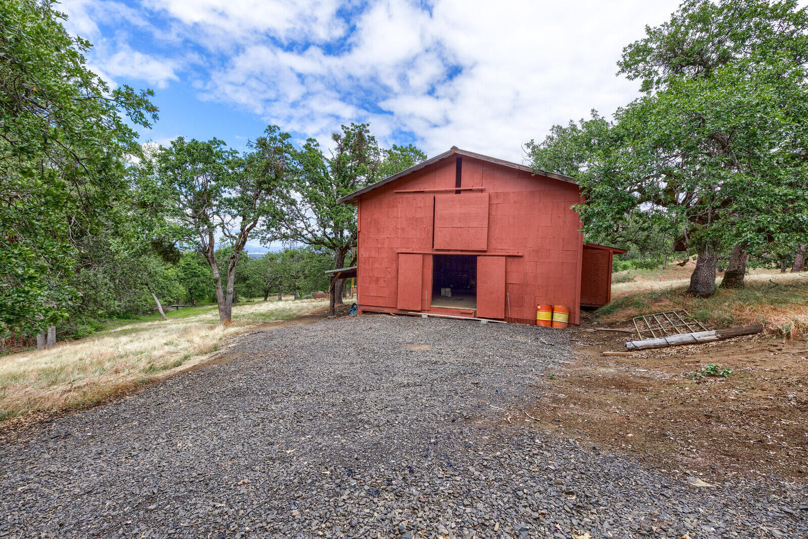 3181 Old Stage Road Central Point, OR 97502 - Photo 66 of 78 a view of a barn in the middle of a yard
