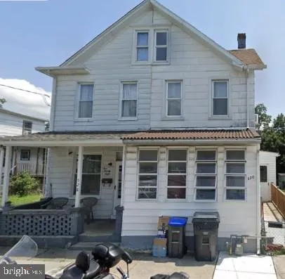 a front view of a house with outdoor space
