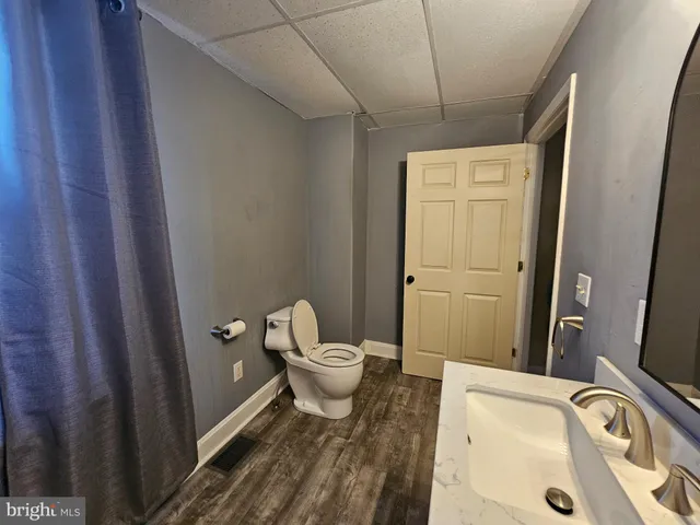 a bathroom with a sink mirror toilet and shower