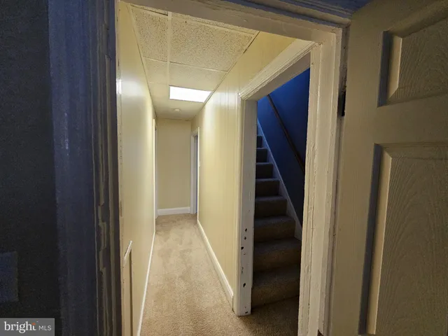 a view of a room with wooden floor and cabinets