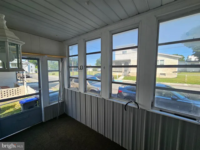 a view of an entryway with wooden floor