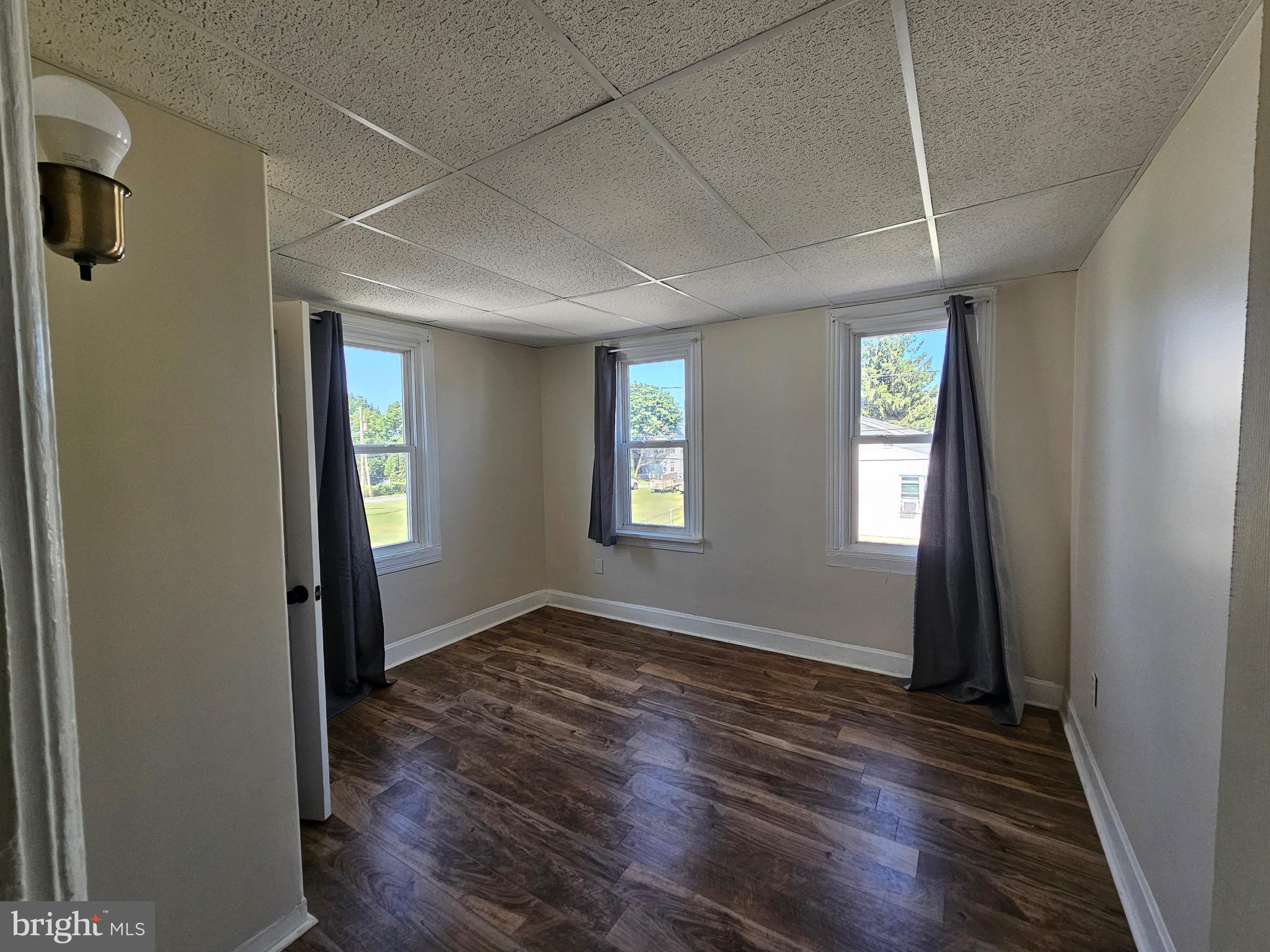 526 Ridge Street Steelton, PA 17113 - Photo 10 of 19 an empty room with wooden floor and windows