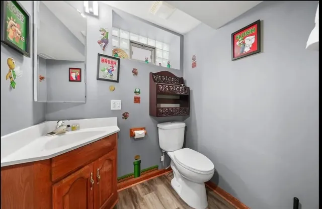 a bathroom with a sink a toilet and a shower