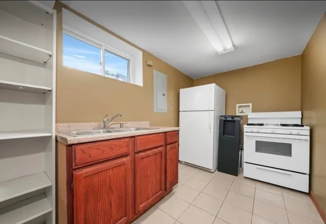 a kitchen with a sink cabinets and stainless steel appliances