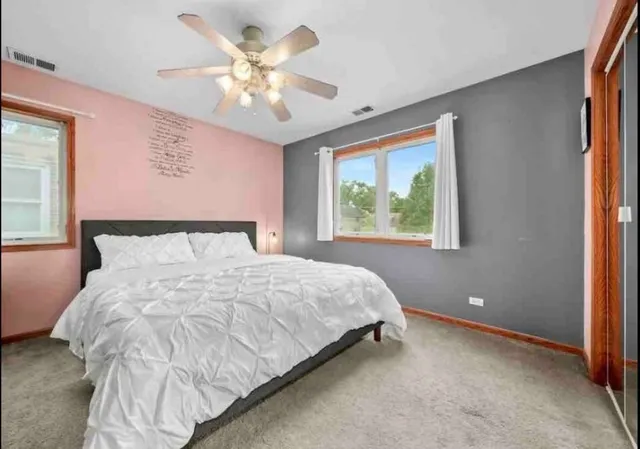 a bedroom with a large bed and a window