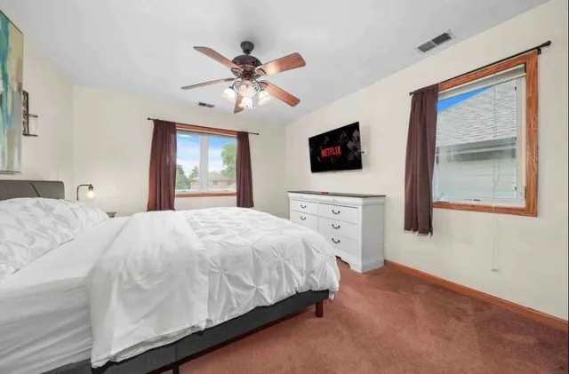 a bedroom with a bed and a flat screen tv