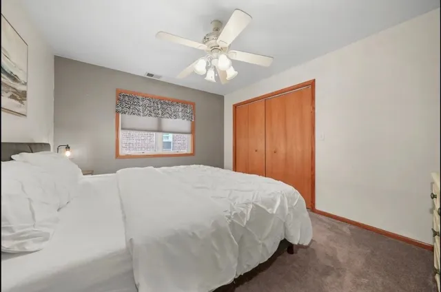 a bedroom with a large bed and a window