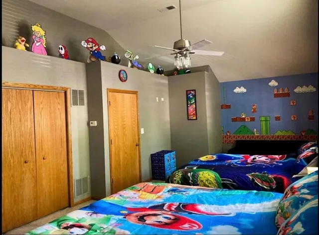 a bedroom with a bed chandelier and a window