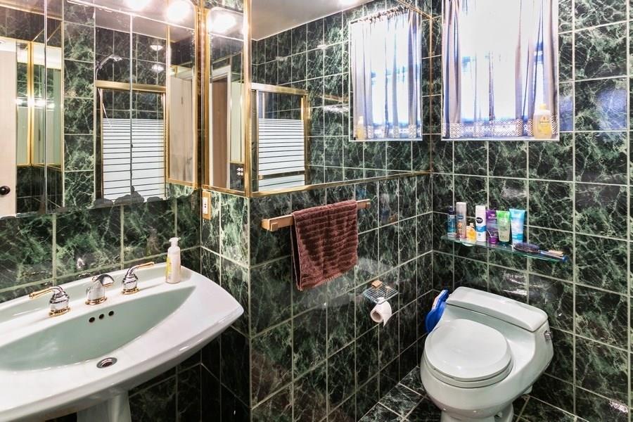 1270 East 98th Street Brooklyn, NY 11236 - Photo 19 of 23 a bathroom with a sink a toilet and a mirror