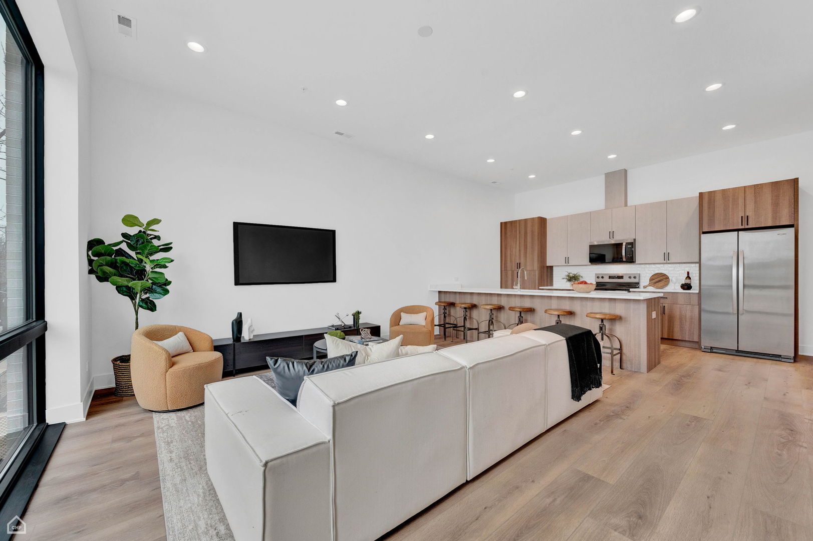1626 West Hastings Street, Unit 301 Chicago, IL 60608 - Photo 3 of 20 a living room with furniture kitchen and a flat screen tv