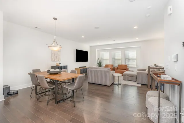 a dining area with a table chairs and a kitchen view