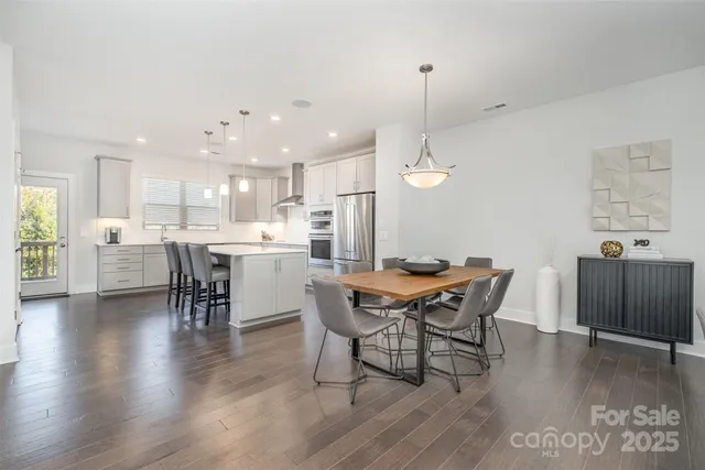 a large kitchen with cabinets table and chairs