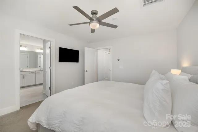 a large white bed in a white room