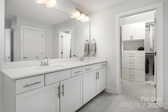 a bathroom with a shower sink vanity and mirror