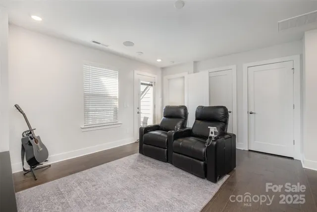 a living room with furniture a window and a wooden floor
