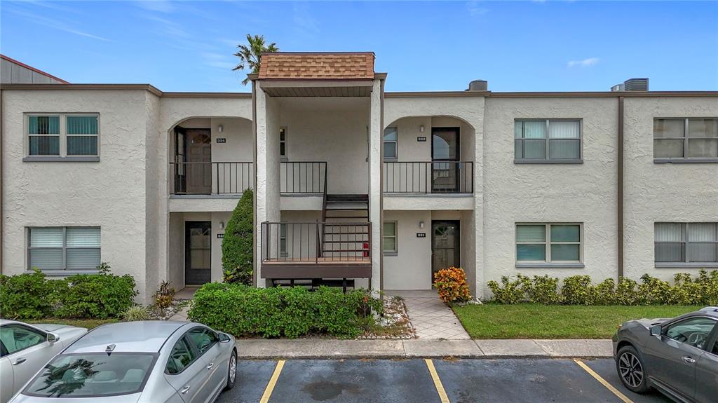 7701 Starkey Road, Unit 324 Seminole, FL 33777 - Photo 1 of 1 a front view of a house with garden