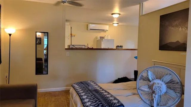 a bedroom with a bed and teddy bear on dresser