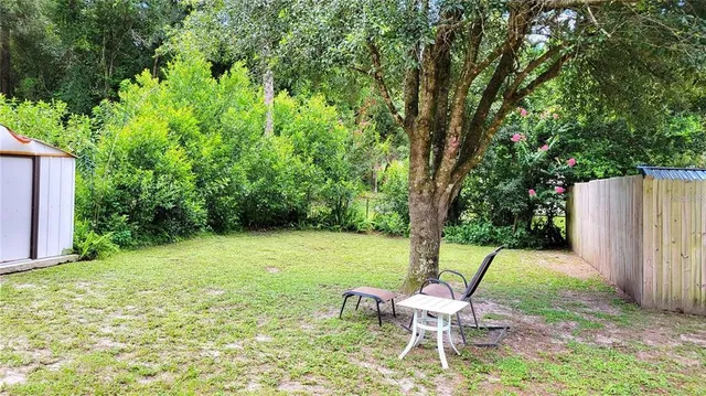 a chair and table sitting in backyard of house