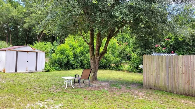 a view of a chair and table in the garden