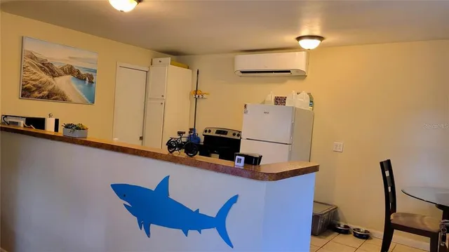 a room with table chairs and wooden floor