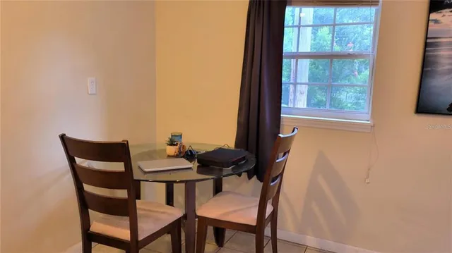 a dining room with furniture and window