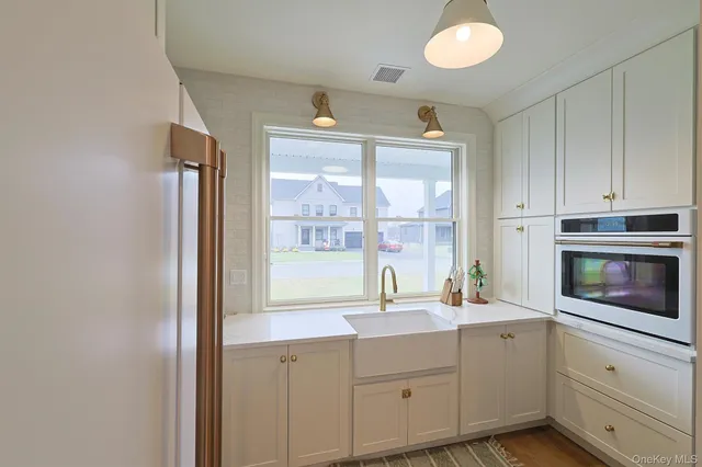 a kitchen with cabinets stainless steel appliances and a sink