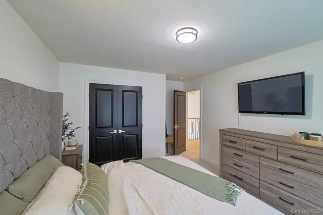 a bedroom with furniture a rug and a window