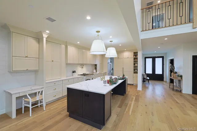 a open kitchen with a sink stove and wooden floor
