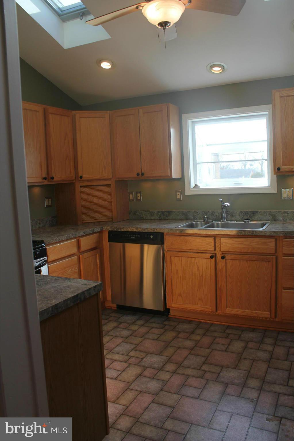 650 North Bend Road Baltimore, MD 21229 - Photo 11 of 22 a kitchen with stainless steel appliances granite countertop a sink a stove cabinets and wooden floor
