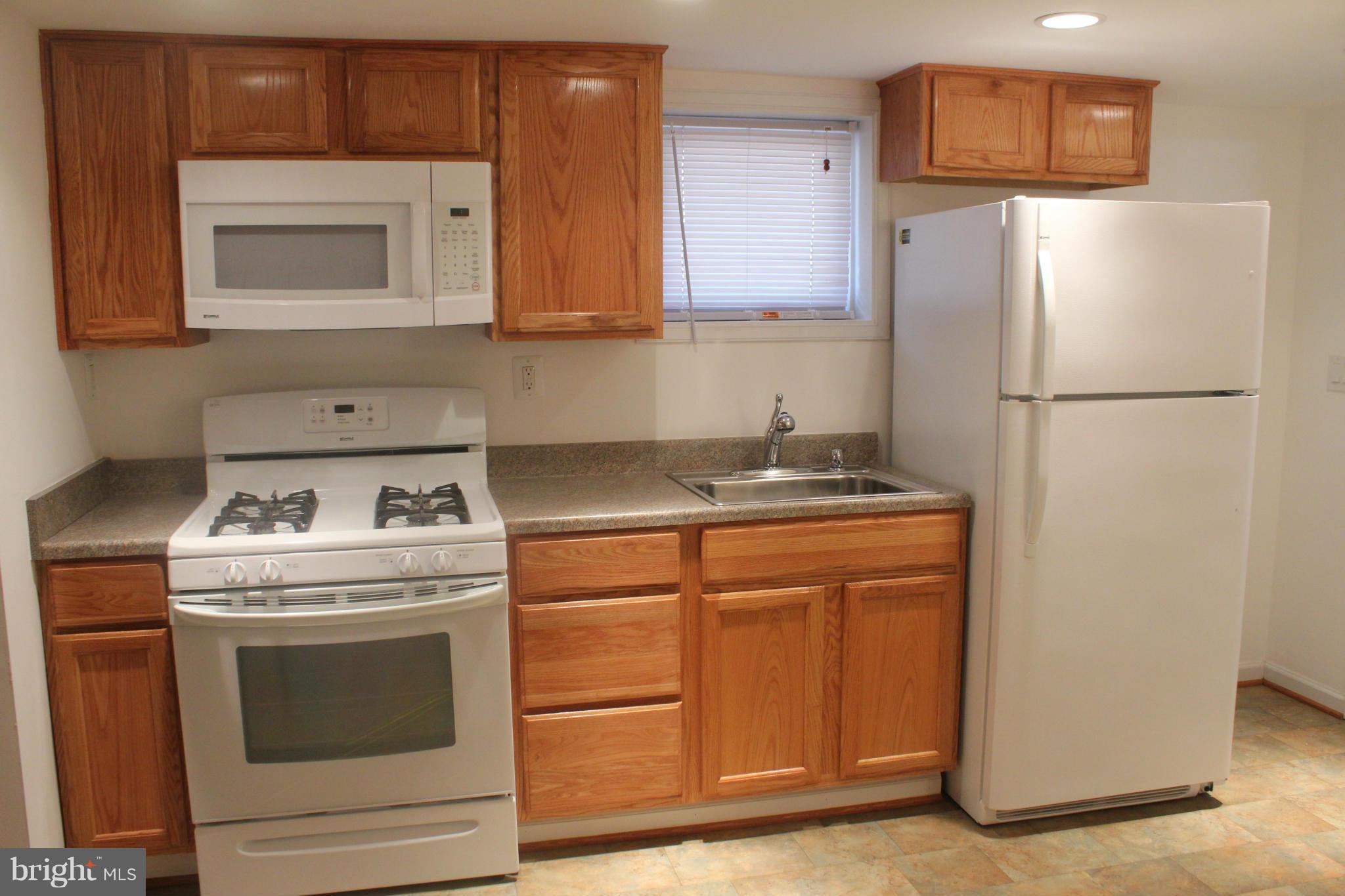650 North Bend Road Baltimore, MD 21229 - Photo 20 of 22 a kitchen with granite countertop a refrigerator stove and sink