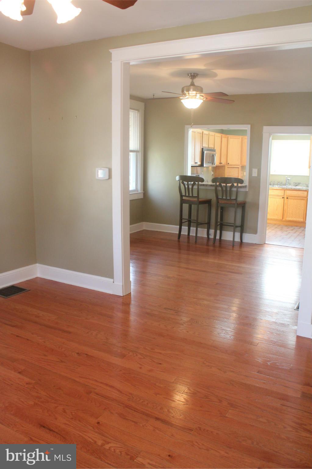 650 North Bend Road Baltimore, MD 21229 - Photo 3 of 22 a view of a living room and kitchen with wooden floor