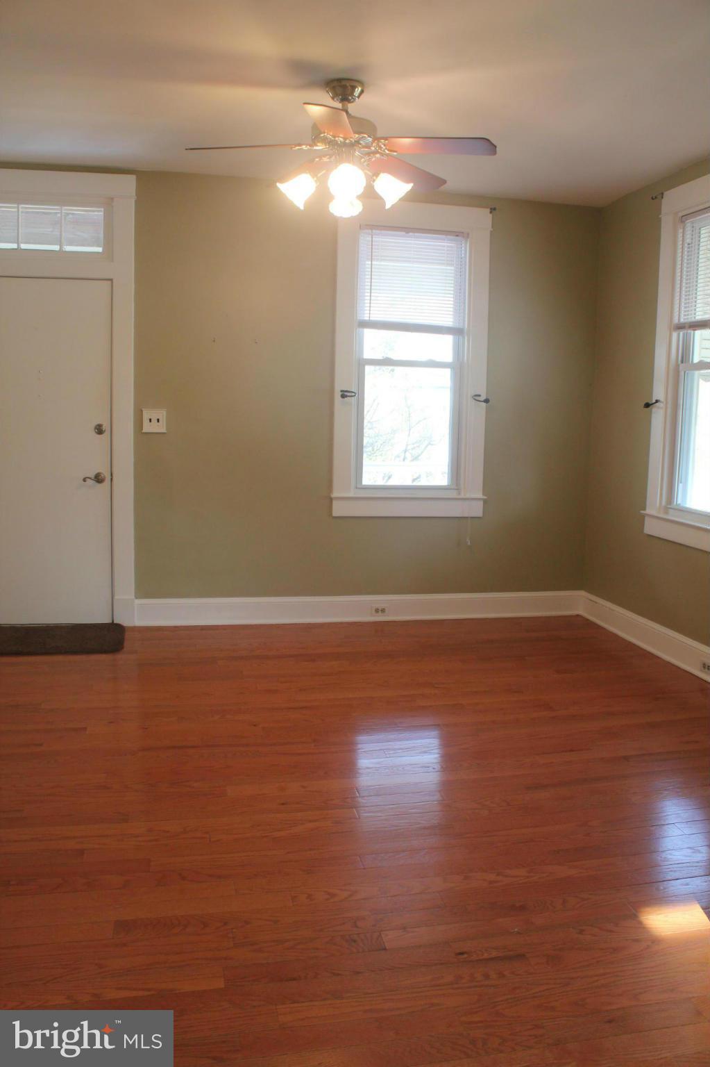 650 North Bend Road Baltimore, MD 21229 - Photo 4 of 22 wooden floor in an empty room with a window