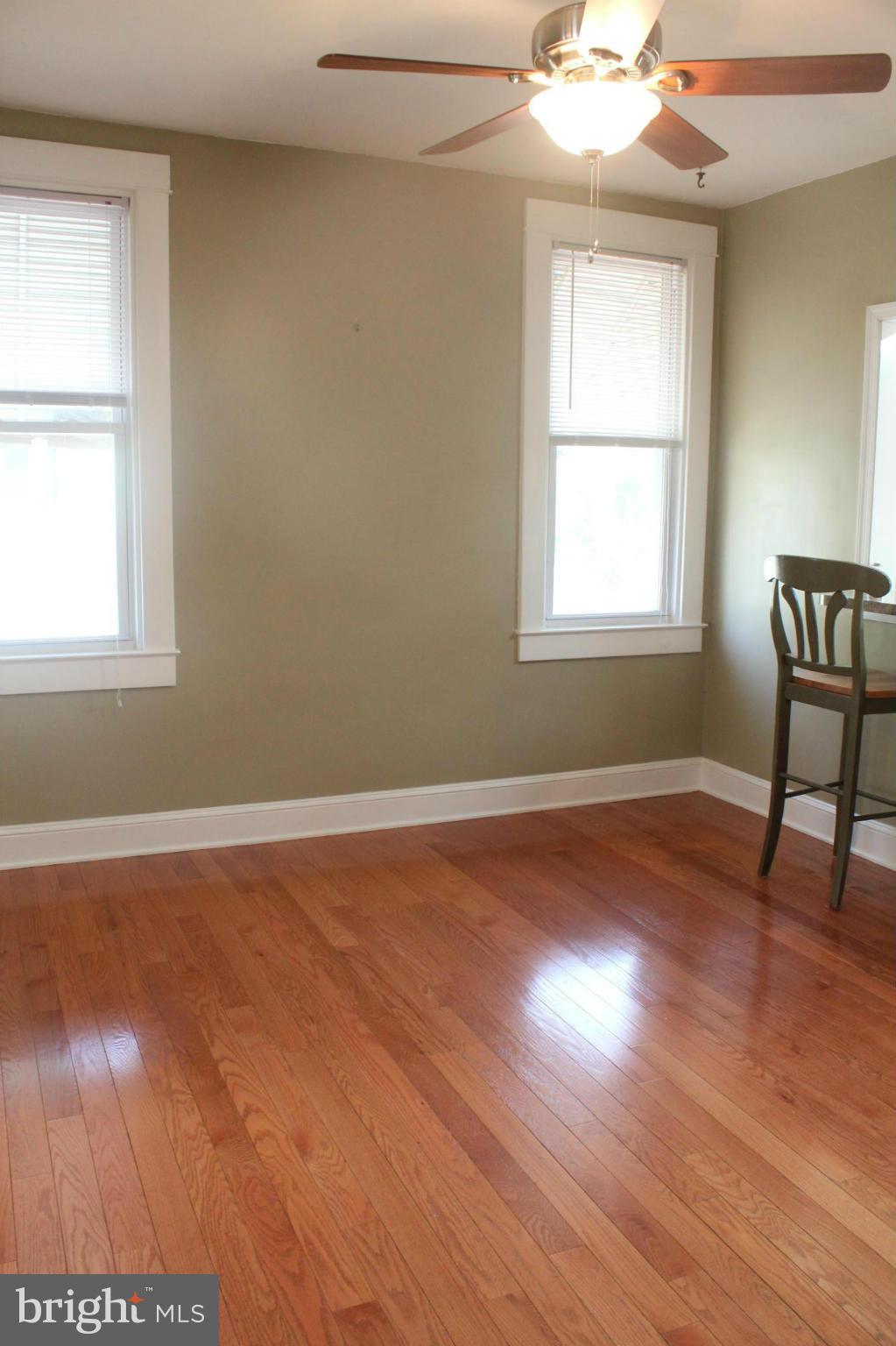 650 North Bend Road Baltimore, MD 21229 - Photo 6 of 22 an empty room with wooden floor and windows